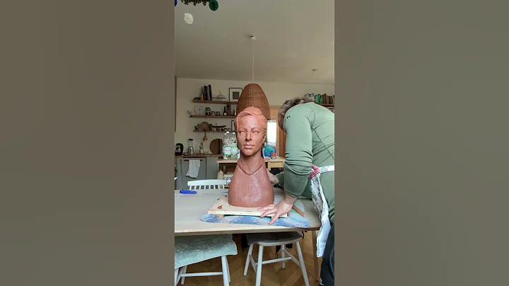 Hollowing terracotta portrait for firing .