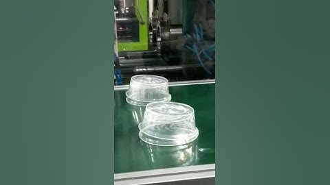 injection molding robot working manufacturing of polypropylene disposable food containers.