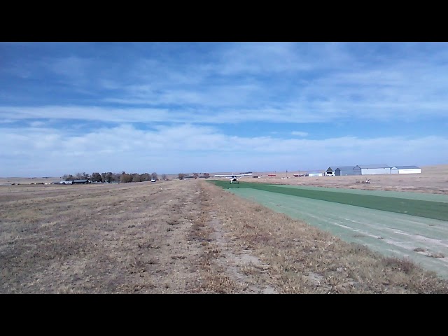 Stinson 108 taking off from Runway 17 at the Calhan Colorado Airport.