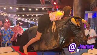 Girl In Shiny Clothes Riding On A Bull In Benidorm | Bull Riding 4K