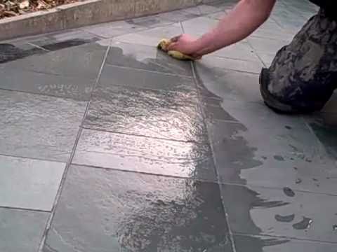 Removing excess grout residue with sponge