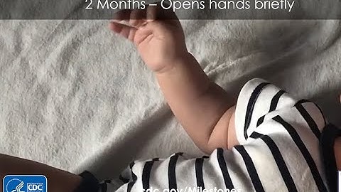 2-Months Opens hands briefly