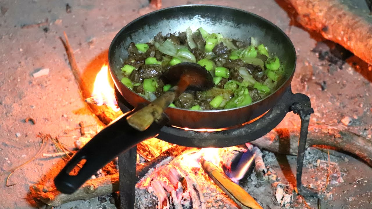 Braised Beef Liver with Onion and Green Pepper on Traditional Fireplace