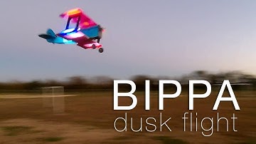 Bippa - illuminated, scratch-built biplane at dusk