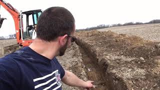 How to traverse an open trench with a miniexcavator.