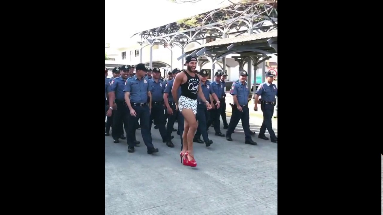 Sinon Loresca teaching the PNP officers how to do a catwalk