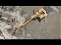 Cat 345DL Excavator digging in extreme mud