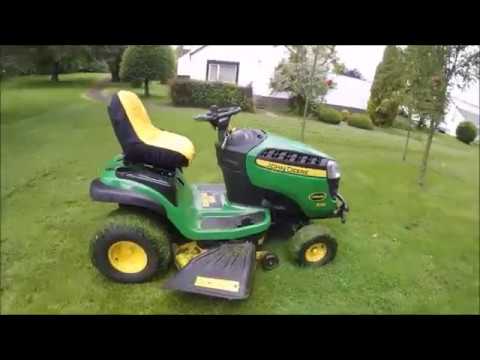 Mowing on john deere x125 cutting grass