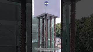 Precast concrete column with inner sleeve guide holes installs onto foundation rebar cage