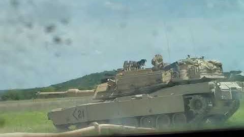 Drivers view of nearby M1A2 Abrams firing its main gun.