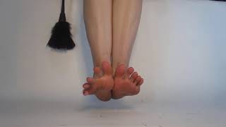 Woman With Red Toenails Tickling Feet With Feathers