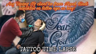 Black and Grey Shaded Angel Wings Fear God Tattoo Nepali Guy Client