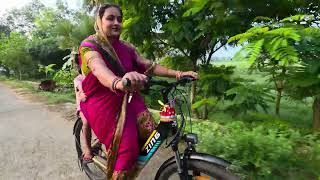Monalisa riding Electric cycle for picking Lily flowers Early of Morning. 