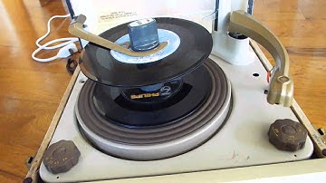 Decca record player playing a stack of 45 RPM records