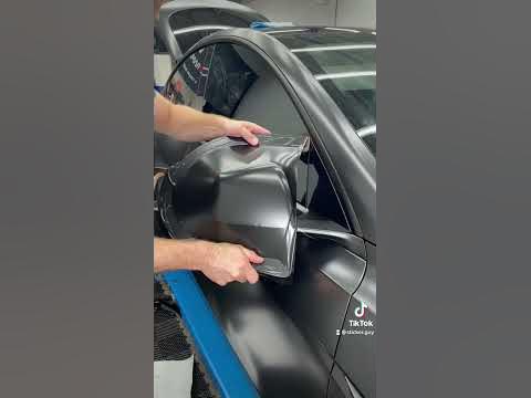 Vinyl wrapping the mirror on Tesla Model Y. 