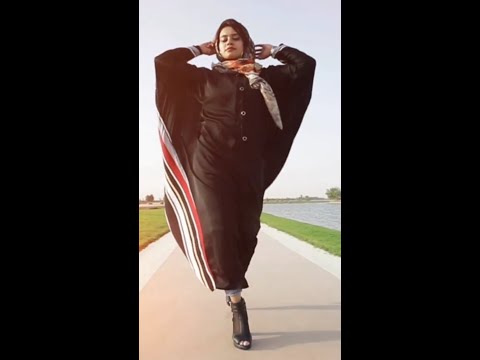 Arabic girl wearing hijab walking down the street like modeling girls