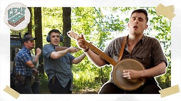 Sam Shackleton playin banjo and shootin at Benjamin Tod