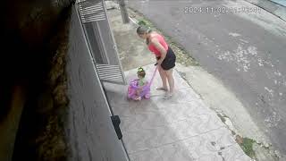 Baby Stroller Tips Over as Woman Tries to Pull It Through the Doorway