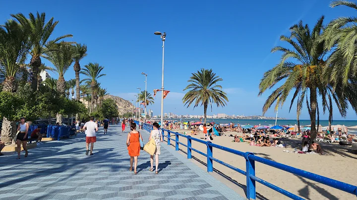 Walking along the Spanish beach. Playa del Postiguet, Alicante, Spain