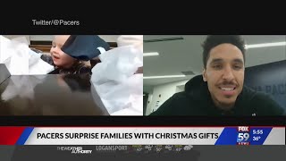 Pacers players surprise families with christmas gifts.