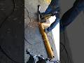 USING CUTTING DISC MOUNTED ON A PORTABLE GRINDER TO CHOP OUT BENT ROD FROM DAMAGED HYDRAULIC PISTON