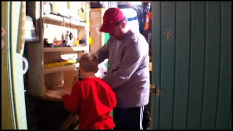 Larson and Daddy build a birdhouse.