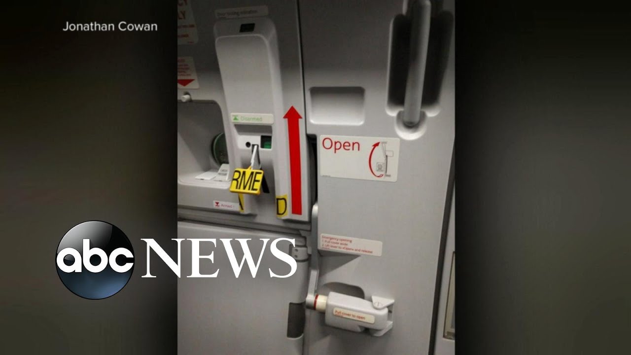 british tourist tries to open door on flight