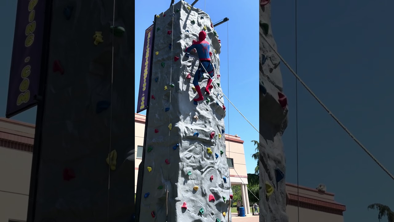 Spider-Man climbs a rock wall