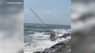 10 rescued from sinking sailboat after hitting rocks at the Jersey shore