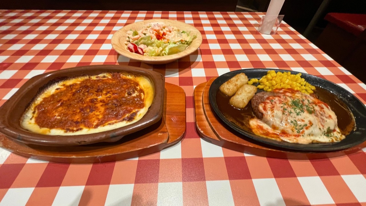 A Japanese salaryman eating lots of Italian food after work.