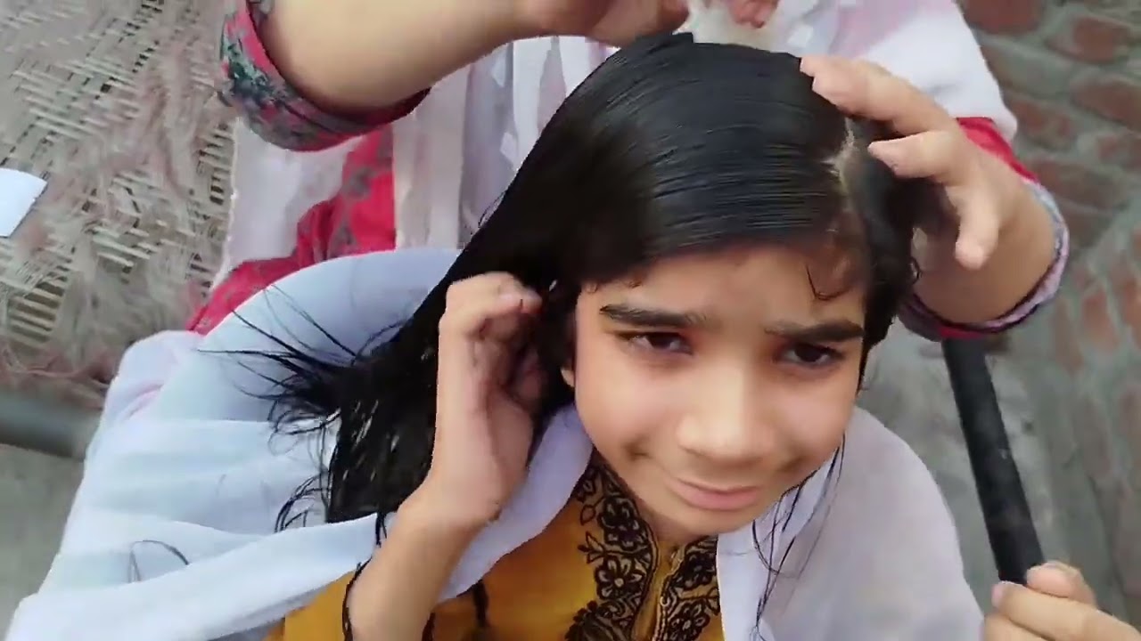 Hair checking of Meerab by mom.