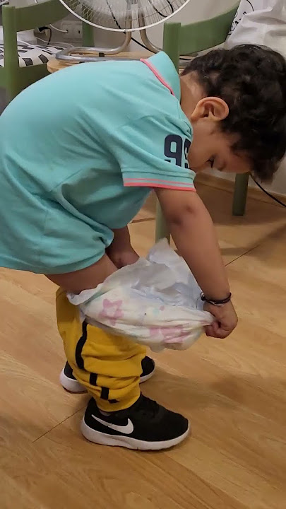 baby removing his diaper alone