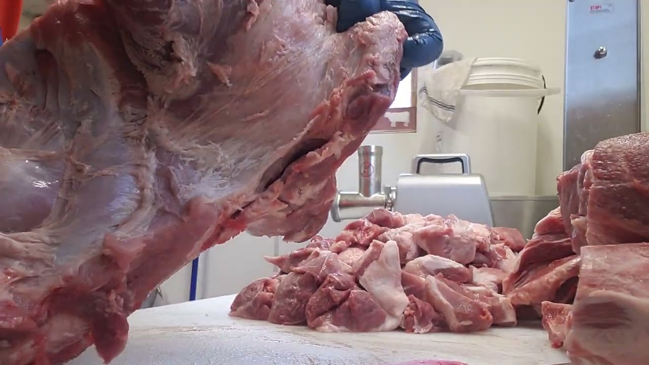 Removing the coppa from a bone in pork butt