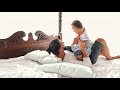 Happy Family Idyll Little Child Daughter Jump On Father Arms And They Fall On A Bed