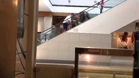 Woman fall on escalator.