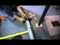 Removing a lally column that is embedded in a concrete floor.