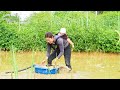morning to night:poor single mother carries her kid on her back while catching fish to sell and cook
