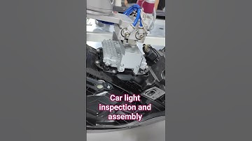 Two robots doing headlight inspection and assembly
