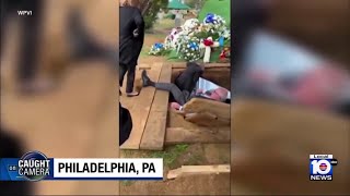 Pallbearers fall into grave during burial in Philadelphia
