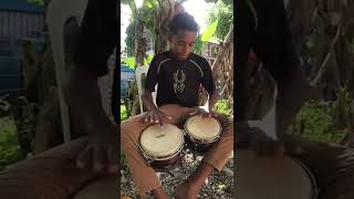 Child bachatero playing bongo bachata