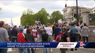 A large crowd of protesters gathered monday afternoon on beacon street
outside the gate massachusetts state house to push for reopening
econo...