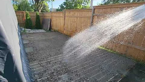 Adding mortar mix to gravel driveway.