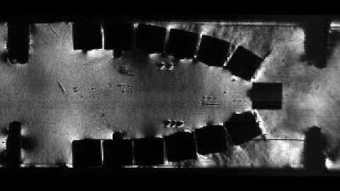 Schlieren Video of a Shock Wave Passing through a Logarithmic Spiral Arrangement of Square Blocks