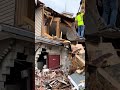 Men recover an American Flag from a demolished building!