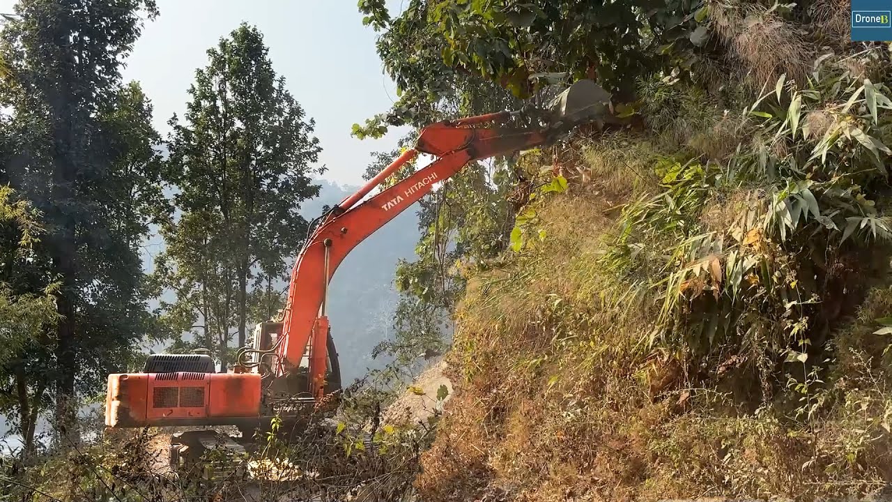 Excavator Widening Narrow Rural Mountain Road for Easier Travel and Village Access