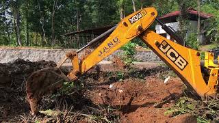 jcb 3dx removing waste plants from canal and preparing land for cultivation