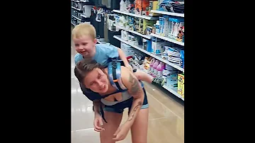 Toddler Tickling His Mom While Strapped To Her Back Shorts 