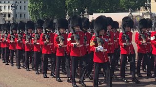 Hundreds of King's guards marching in scorching weather.