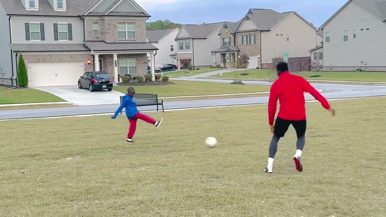 David practicing soccer skills with his young brother 