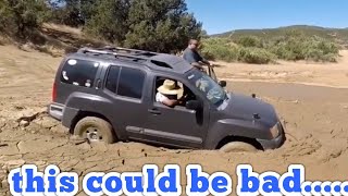 this could be bad.....  nissan xterra stuck in the mud.  Overland build?